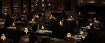 Movie still from “The Founder” (2016), directed by John Lee Hancock – A group of people sitting at a table in a restaurant; Wide shot, High angle