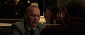 Movie still from “The Founder” (2016), directed by John Lee Hancock – A person wearing a suit and tie; Close Up shot, Over the shoulder angle