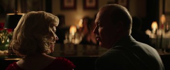 Movie still from “The Founder” (2016), directed by John Lee Hancock – A man and a woman sitting at a table in front of candles; Close Up shot, Over the shoulder angle