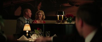 Movie still from “The Founder” (2016), directed by John Lee Hancock – Two people sitting at a table in front of a mirror; Medium shot, Over the shoulder angle