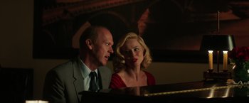 Movie still from “The Founder” (2016), directed by John Lee Hancock – A man and a woman sitting next to each other at a piano; Medium shot, Over the shoulder angle