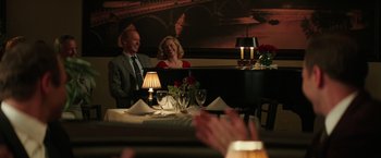Movie still from “The Founder” (2016), directed by John Lee Hancock – A man and a woman sitting in front of a grand piano; Medium shot, Over the shoulder angle