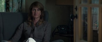 Movie still from “The Founder” (2016), directed by John Lee Hancock – A woman sitting in a chair in front of a phone; Close Up shot, Low angle