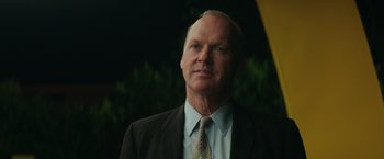 Movie still from “The Founder” (2016), directed by John Lee Hancock – A person wearing a suit and tie; Close Up shot, Low angle