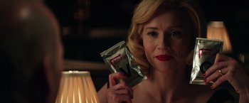 Movie still from “The Founder” (2016), directed by John Lee Hancock – A woman is holding a condom in her hand; Close Up shot, Over the shoulder angle