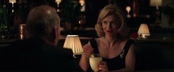 Movie still from “The Founder” (2016), directed by John Lee Hancock – A man and a woman sitting at a table with a glass of milk in front of them; Close Up shot, Over the shoulder angle