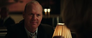 Movie still from “The Founder” (2016), directed by John Lee Hancock – A person wearing a suit and tie; Close Up shot, Over the shoulder angle