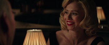 Movie still from “The Founder” (2016), directed by John Lee Hancock – A woman with red lipstick sitting in front of a lamp; Close Up shot, Over the shoulder angle