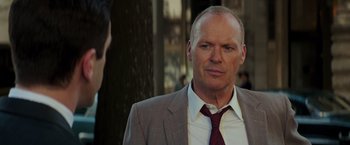 Movie still from “The Founder” (2016), directed by John Lee Hancock – A man in a suit and a red neck tie; Close Up shot, Over the shoulder angle