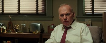 Movie still from “The Founder” (2016), directed by John Lee Hancock – A man in a white dress shirt and red tie; Close Up shot, Low angle