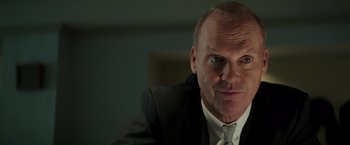 Movie still from “The Founder” (2016), directed by John Lee Hancock – A man in a suit and tie looking at the camera; Close Up shot, Low angle
