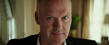 Movie still from “The Founder” (2016), directed by John Lee Hancock – An older man wearing a black jacket and a white shirt; Close Up shot, Low angle