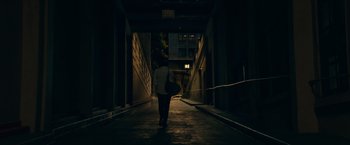 Movie still from “A Star Is Born” (2018), directed by Bradley Cooper – A person walking down a dark alley at night; Extreme Wide shot, Low angle