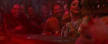 Movie still from “A Star Is Born” (2018), directed by Bradley Cooper – A man and woman sitting at a bar; Medium shot, Over the shoulder angle