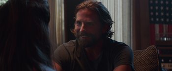 Movie still from “A Star Is Born” (2018), directed by Bradley Cooper – A person with long hair and a beard; Close Up shot, Over the shoulder angle