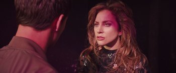 Movie still from “A Star Is Born” (2018), directed by Bradley Cooper – A woman looking into a mirror while standing next to a man; Close Up shot, Over the shoulder angle