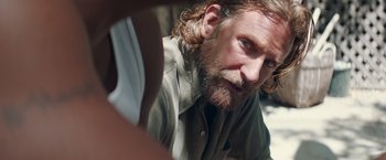 Movie still from “A Star Is Born” (2018), directed by Bradley Cooper – A person with long hair and a beard; Close Up shot, Over the shoulder angle
