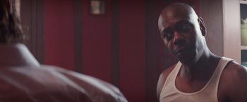 Movie still from “A Star Is Born” (2018), directed by Bradley Cooper – A man sitting in front of a mirror in a room; Close Up shot, Over the shoulder angle