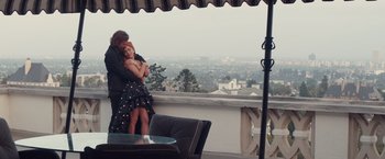 Movie still from “A Star Is Born” (2018), directed by Bradley Cooper – A man and a woman hugging on a balcony; Wide shot, Overhead angle