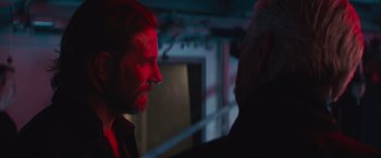 Movie still from “A Star Is Born” (2018), directed by Bradley Cooper – A man with a beard is talking to another man; Close Up shot, Over the shoulder angle
