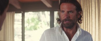 Movie still from “A Star Is Born” (2018), directed by Bradley Cooper – A person with a beard; Close Up shot, Over the shoulder angle