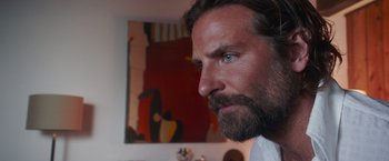 Movie still from “A Star Is Born” (2018), directed by Bradley Cooper – A person with a beard; Close Up shot, Over the shoulder angle