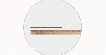 Movie still from “A Trip to Infinity” (2022), directed by Jonathan Halperin – A wooden ruler is shown in front of an image; Extreme Close Up shot, Overhead angle