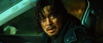 Movie still from “A Writer's Odyssey” (2021), directed by Yang Lu – A person wearing a jacket; Close Up shot, Low angle