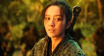 Movie still from “A Writer's Odyssey” (2021), directed by Yang Lu – A woman with a sword in her hand; Close Up shot, Low angle