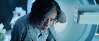 Movie still from “A Writer's Odyssey” (2021), directed by Yang Lu – A person wearing a suit and tie; Close Up shot, Low angle