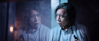 Movie still from “A Writer's Odyssey” (2021), directed by Yang Lu – A man looking at himself in the mirror; Close Up shot, Over the shoulder angle