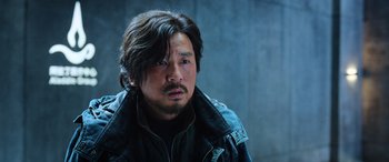 Movie still from “A Writer's Odyssey” (2021), directed by Yang Lu – A person wearing a jacket; Close Up shot, Low angle