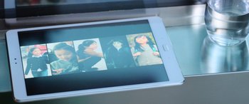 Movie still from “A Writer's Odyssey” (2021), directed by Yang Lu – A picture of a woman on the screen of an electronic device; Extreme Close Up shot, Overhead angle
