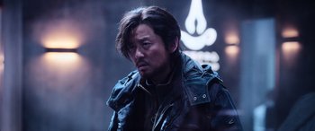 Movie still from “A Writer's Odyssey” (2021), directed by Yang Lu – A person wearing a jacket; Close Up shot, Low angle