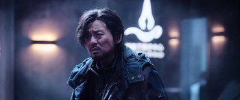 Movie still from “A Writer's Odyssey” (2021), directed by Yang Lu – A person wearing a jacket; Close Up shot, Low angle