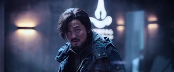 Movie still from “A Writer's Odyssey” (2021), directed by Yang Lu – A person wearing a jacket; Close Up shot, Low angle