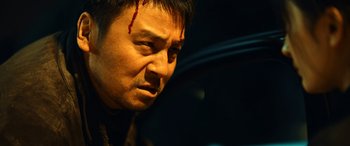 Movie still from “A Writer's Odyssey” (2021), directed by Yang Lu – A person with blood on his face; Close Up shot, Low angle
