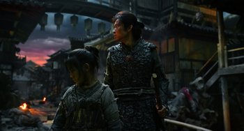 Movie still from “A Writer's Odyssey” (2021), directed by Yang Lu – A woman and a child dressed in ancient clothing; Medium shot, Over the shoulder angle