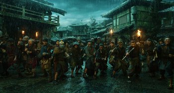 Movie still from “A Writer's Odyssey” (2021), directed by Yang Lu – A group of people walking down a street in the rain; Wide shot, High angle