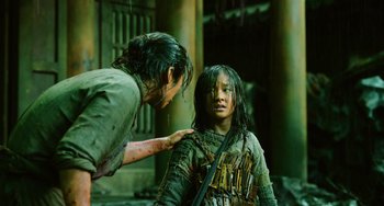 Movie still from “A Writer's Odyssey” (2021), directed by Yang Lu – A man is touching a woman's face in the rain; Medium shot, Over the shoulder angle