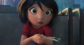 Movie still from “Abominable” (2019), directed by Todd Wilderman – A girl is sitting on the ground holding a pair of scissors in her hand; Close Up shot, High angle