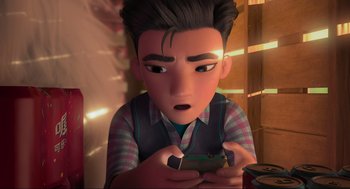 Movie still from “Abominable” (2019), directed by Todd Wilderman – A boy is holding a cell phone and looking surprised; Close Up shot, High angle