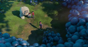 Movie still from “Abominable” (2019), directed by Todd Wilderman – Two kids standing next to an animal in a field; Extreme Wide shot, Overhead angle