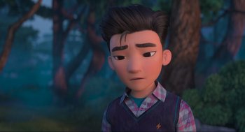 Movie still from “Abominable” (2019), directed by Todd Wilderman – A cartoon boy with dark brown hair and a plaid shirt; Close Up shot, Over the shoulder angle