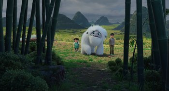 Movie still from “Abominable” (2019), directed by Todd Wilderman – Two kids standing next to an animal in the grass; Wide shot, Low angle