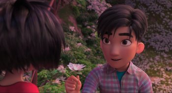 Movie still from “Abominable” (2019), directed by Todd Wilderman – A person holding a flower in front of another person; Close Up shot, Over the shoulder angle