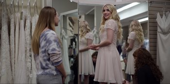 Movie still from “About Fate” (2022), directed by Marius Vaysberg – A woman in a dress looking in the mirror; Medium shot, Over the shoulder angle