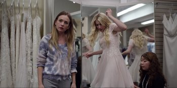 Movie still from “About Fate” (2022), directed by Marius Vaysberg – A woman in a dress looking in the mirror; Medium shot, Over the shoulder angle