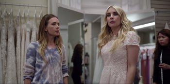 Movie still from “About Fate” (2022), directed by Marius Vaysberg – Two young women standing next to each other in front of a mirror; Medium shot, Over the shoulder angle