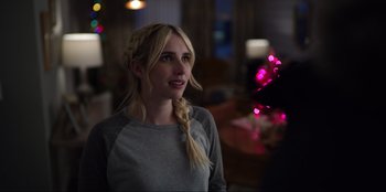 Movie still from “About Fate” (2022), directed by Marius Vaysberg – A woman with blonde hair is standing in a room; Close Up shot, Over the shoulder angle